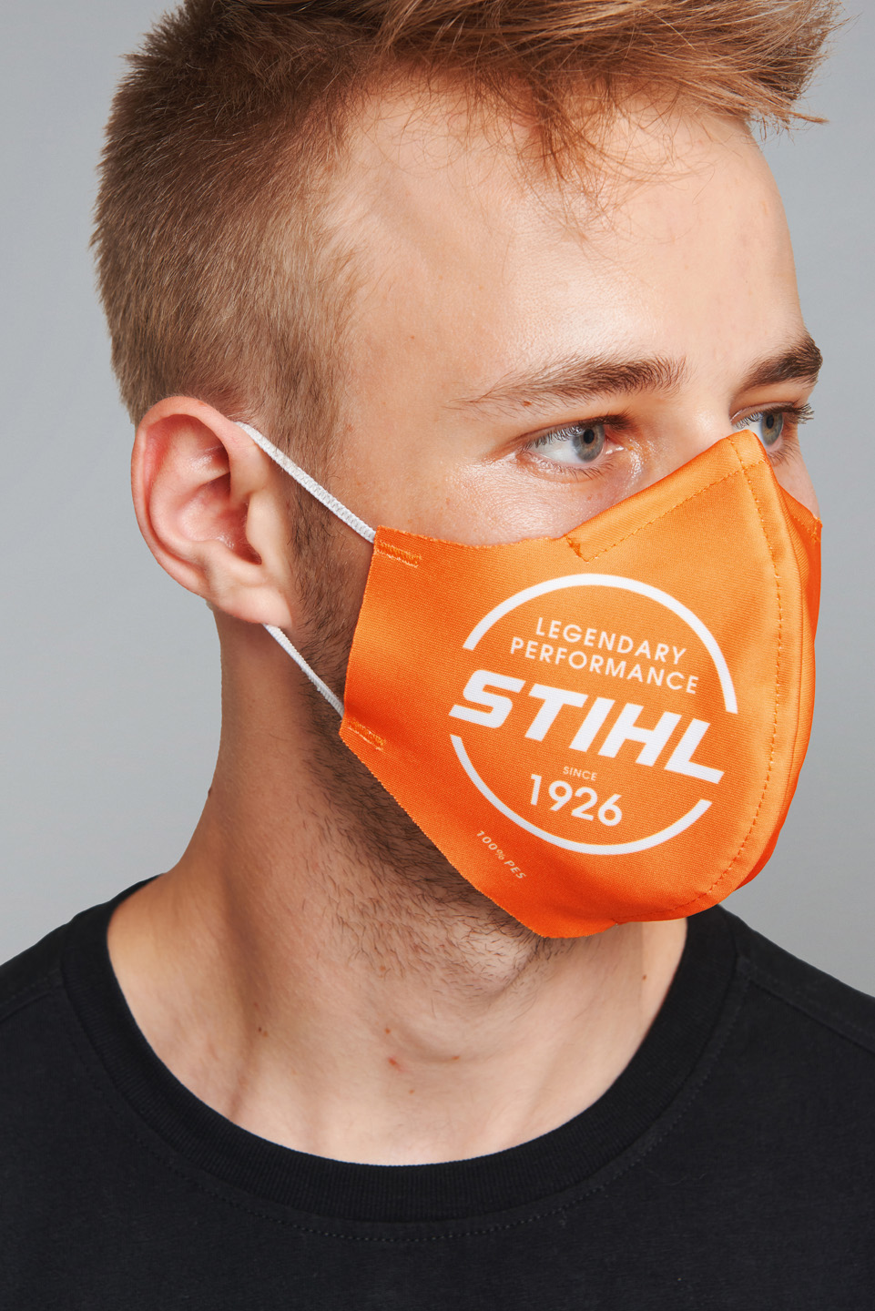 Male model wearing an orange STIHL face mask.