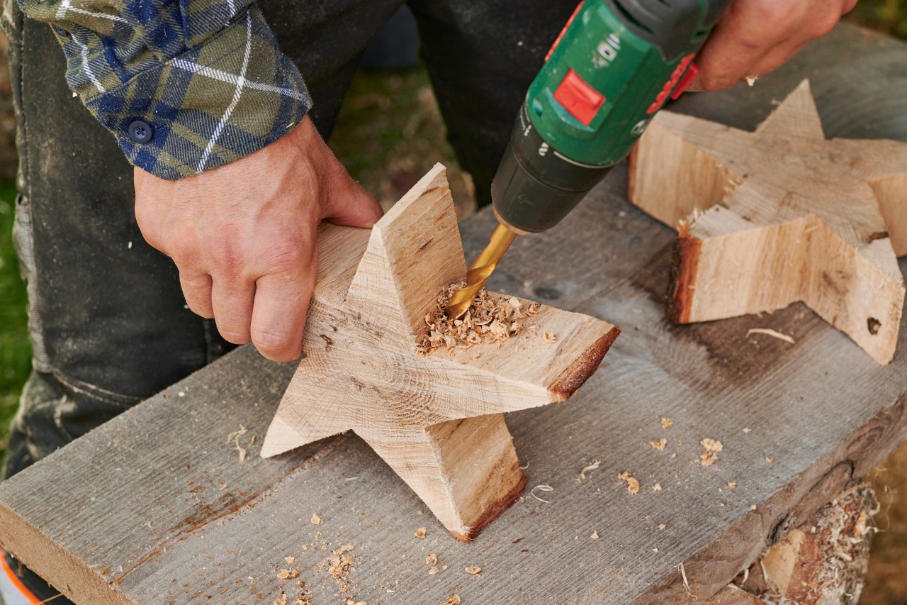 A hole being drilled in the bottom of a wooden star