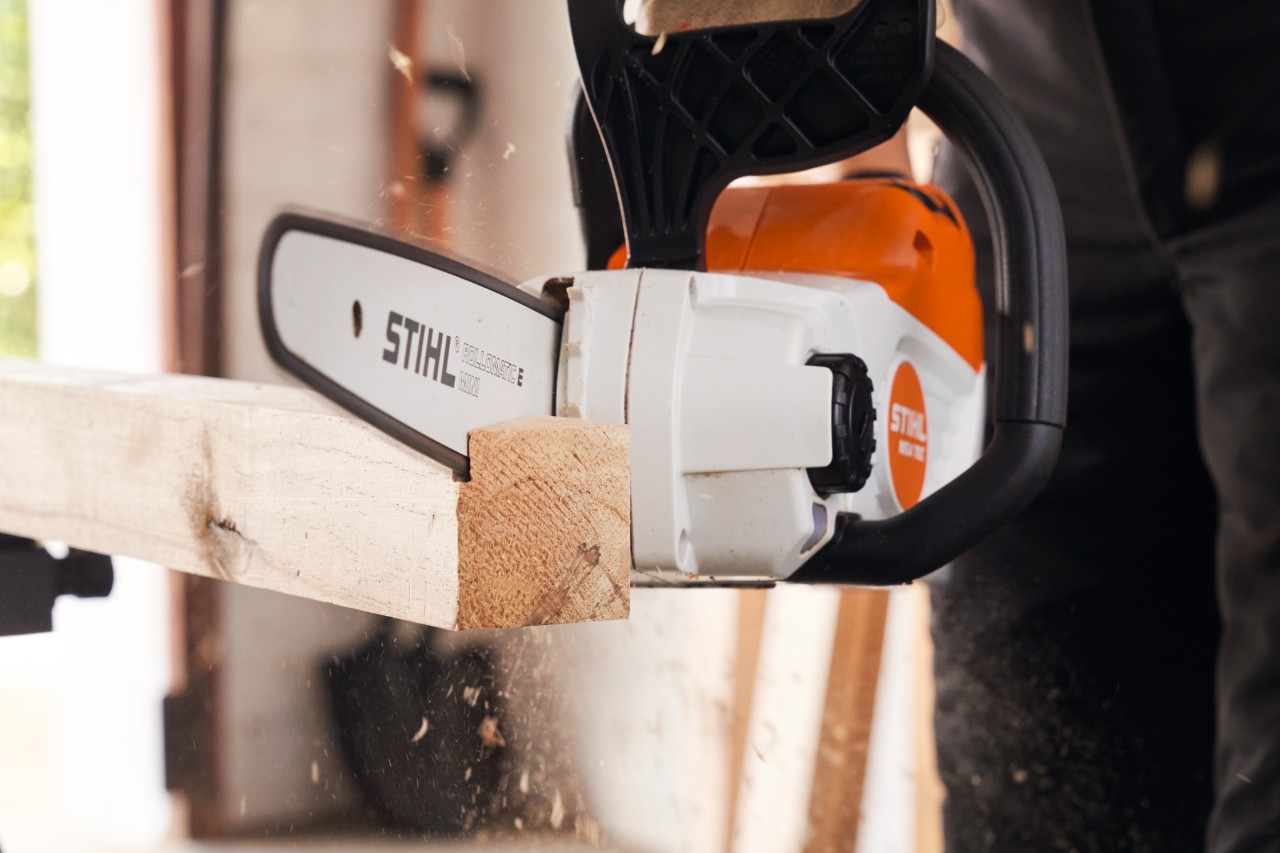 Close-up of how the brackets are cut to size with a STIHL cordless chainsaw