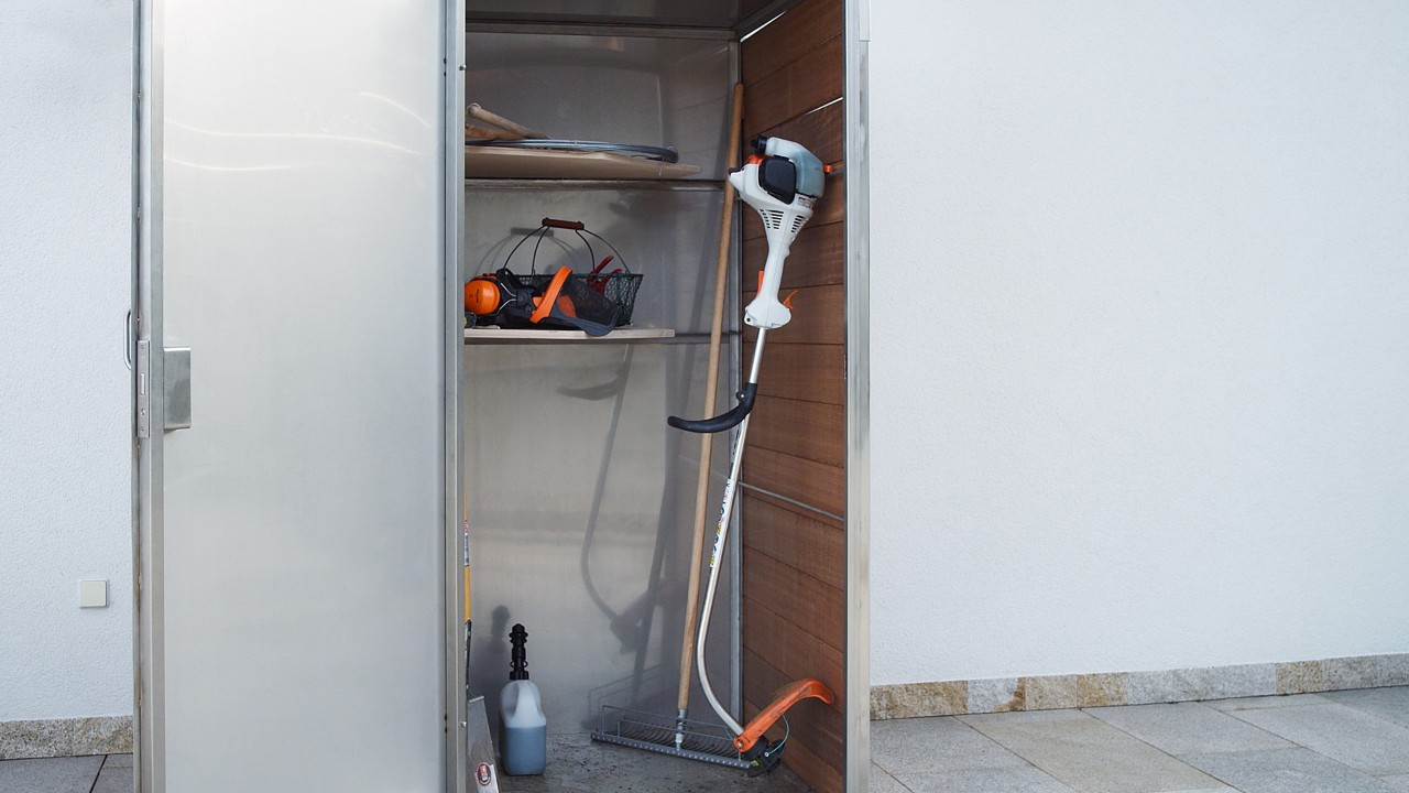 After being switched off, a STIHL FS 38 petrol brushcutter is stored in a cabinet