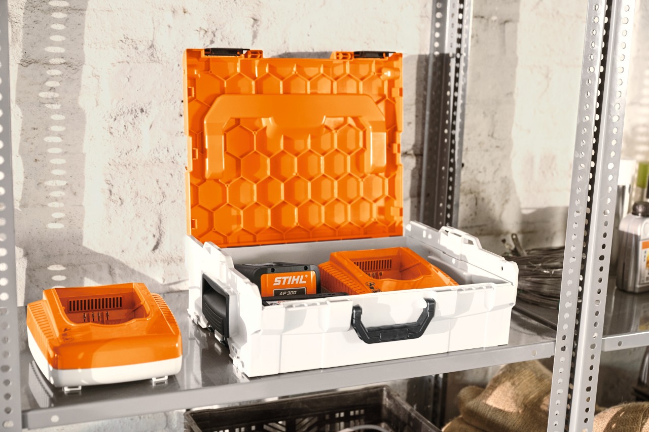STIHL battery box with STIHL lithium-ion batteries on a workshop shelf